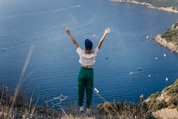 Happy woman standing with her back in nature in summer with open hands posing with mountains. Woman in the mountains, eco friendly, summer landscape active rest