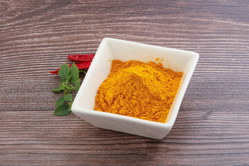Yellow vibrant curcuma powder in the bowl
