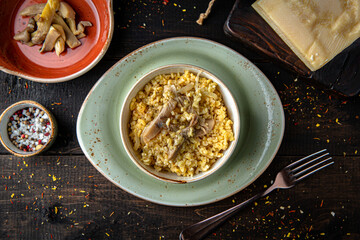 Bulgur with oyster mushrooms and butter. Menu for a restaurant. Beautiful composition on wooden boards.