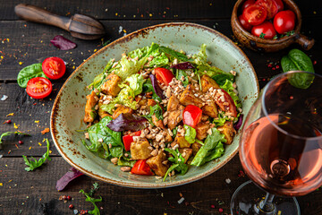 Warm salad of grilled zucchini, fresh vegetables and nuts. Menu for a restaurant. Beautiful composition on wooden boards.