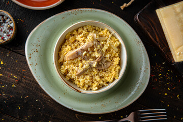Bulgur with oyster mushrooms and butter. Menu for a restaurant. Beautiful composition on wooden boards.