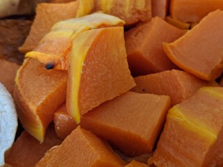 The color is yellow. Baked pumpkin. Tasty dish. Cut into cubes. Heat treatment of garden vegetables