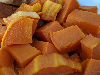 The color is yellow. Baked pumpkin. Tasty dish. Cut into cubes. Heat treatment of garden vegetables