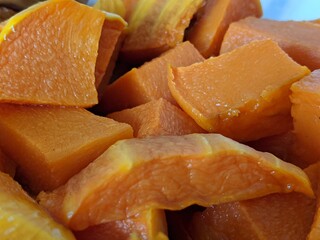 The color is yellow. Baked pumpkin. Tasty dish. Cut into cubes. Heat treatment of garden vegetables