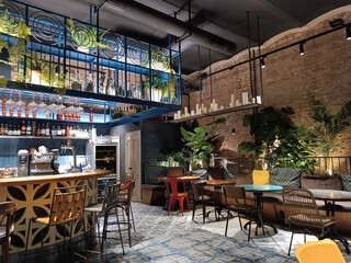 Interior of a modern cozy restaurant with fresh flowers and light interior