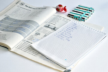 We study English. English textbook and notepad. - obrazy, fototapety, plakaty