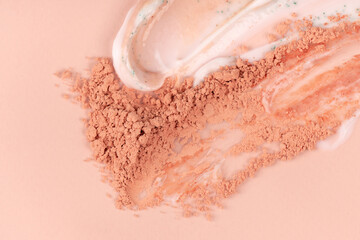 Various smears and drops of cream on a beige background. Skin care cosmetics cream, scrub, powder....