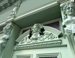 Baroque carved wooden facade with floral design and female icon.