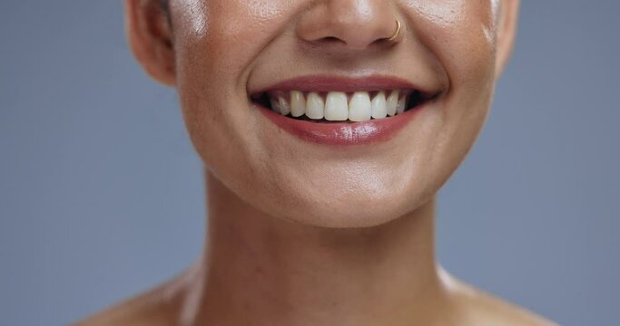 Teeth, mouth and tongue out, woman with beauty or dental, happy for dermatology and orthodontics on grey background. Lick, smile and zoom for oral health, hygiene and wellness with grooming in studio
