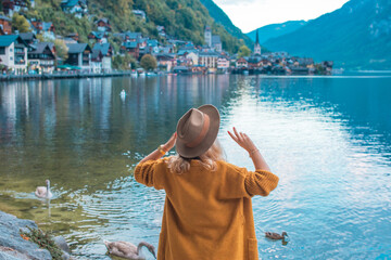 Vacation in Austria. Concept of tourism and holidays. Woman resting in Hallstatt, nature scene