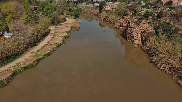 Aerial view of Llobregat river and reveal snowy mountain, Olesa de Montserrat
