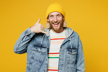 Young happy smiling blond man he wearing denim shirt hoody beanie hat casual clothes doing phone...