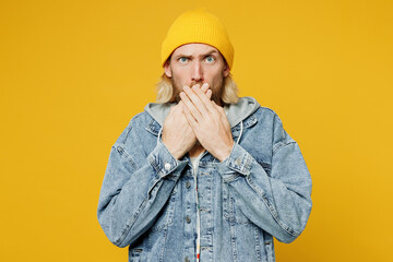 Young frightened sad shocked blond man he wearing denim shirt hoody beanie hat casual clothes look...