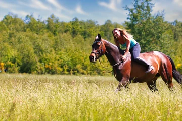Foto op Canvas Woman women with horse riding horses on a summer meadow without a saddle. © RD-Fotografie