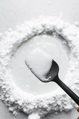 Mixing fondant or gumpaste for decorating cake, making white fondant on a marble surface