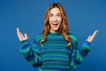 Young shocked surprised excited fun woman she wears knitted sweater casual clothes look camera...