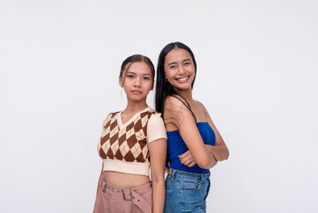 Naklejka premium Two young women smiling and posing on white background