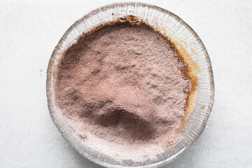 flour and cocoa powder for baking in a glass bowl, a glass mixing bowl with flour and cocoa powder in it, process of making chocolate cake