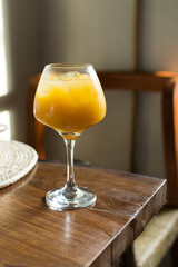 Mimosa cocktails in a wine glass, Orange juice with ice in a wine glass, orange cocktail in a stemmed wine glass