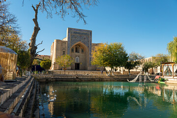 Pond Lyabi Khauz or Khauz Lyab-i Hauz with miniature sights of Bukhara and Nadir Divan-Beghi Khanaka in the background, Uzbekistan - obrazy, fototapety, plakaty