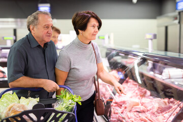 Elderly man and elderly woman choose beef