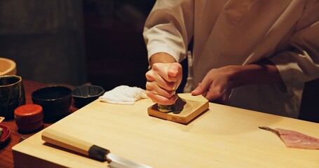Hands, food and wasabi with sushi chef in restaurant for traditional Japanese cuisine or dish closeup. Kitchen, seafood ingredients and preparation and person working with gourmet meal recipe