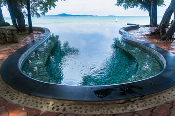 Swimming pool by the sea in the middle of the forest nature