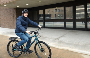 Cyclist in winter at Stony Brook University (SBU), public research university on Long Island in Stony Brook, New York
