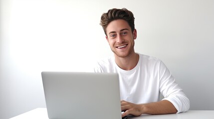 successful Caucasian young man using a laptop, engaged in e-learning and e-commerce