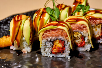 Sushi roll with tuna, shrimp and avocado on a bright background