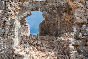 Ancient brick old stones wall arch with sky as the background