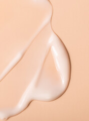 cosmetic smear texture on pastel beige background