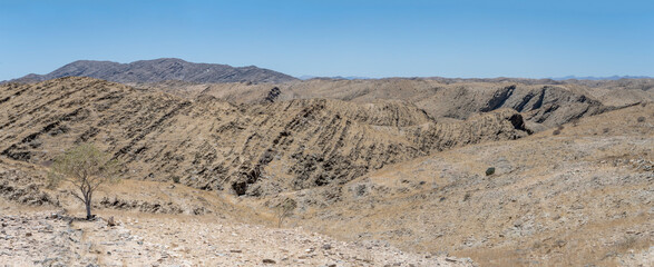 valley with layers and crumble of basalt rocks in Naukluft desert, near Kriess se rus,  Namibia