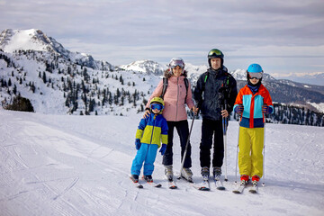 Fototapeta na wymiar Happy family, enjoying ski holiday with children, sunny beautiful weather