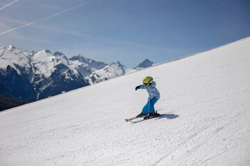 Happy family, enjoying ski holiday with children, sunny beautiful weather