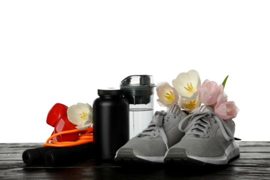 PNG sports goods with flowers on table isolated on white background.