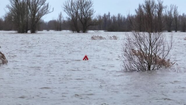 Flooding in the Netherlands along the Waal River in Varik, Gelderland, Underwater road and field