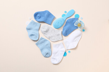 Children's things laid out in the shape of a heart, top view.