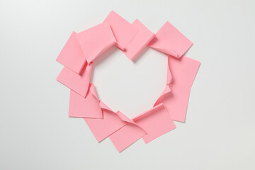 Paper stickers laid out in the shape of a heart, top view.