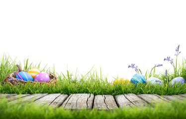 Three painted easter eggs in a birds nest and a line of painted easter eggs in the grass...