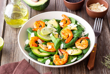 Salad with shrimps, avocado, spinach and almonds. Healthy eating. Diet.