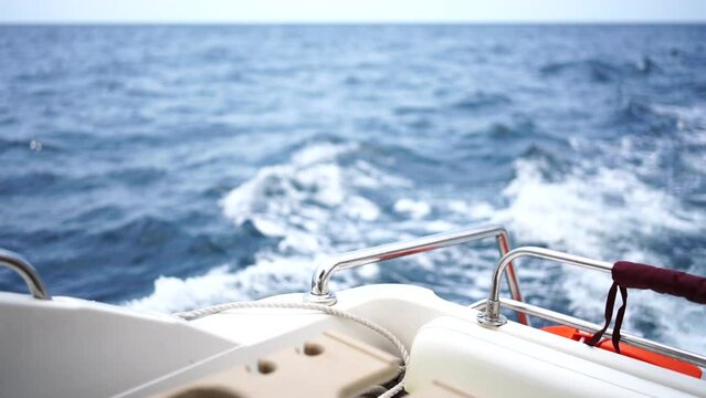 waves of a boat on the blue sea with splashes and a wake from a yacht. Travel and journey concept