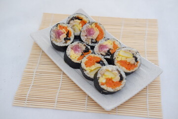 Sushi rolls on a plate on a white background. Japanese food