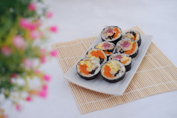 Sushi rolls on a plate on a white background. Japanese food