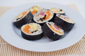 Sushi rolls on a plate on a white background. Japanese food