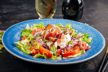 Salad with prosciutto, mozzarella, tomatoes and red onion. Healthy eating. Keto, ketogenic diet.
