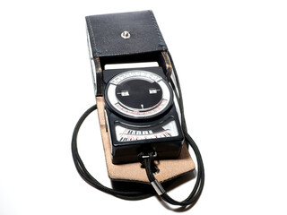 Light meter with leather case on a white background.