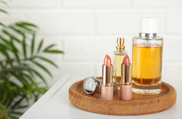 Cosmetic set on light dressing table on light background