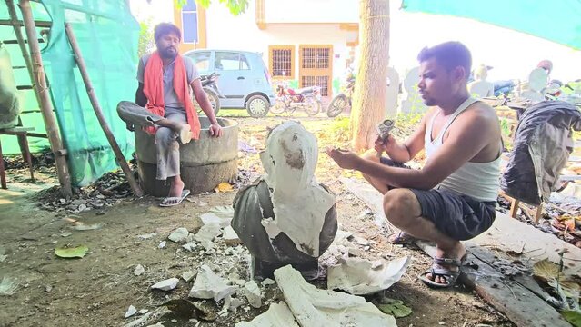 Artist forming fibre half bust human man sculpture, Odisha, India.