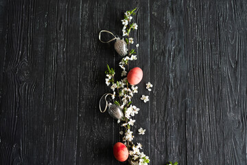 Spring cherry blossoms and Easter eggs on old wooden background. Easter concepts